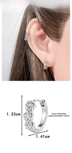 Detail view of silver floral earrings with zircons and 10mm inner diameter dimensions