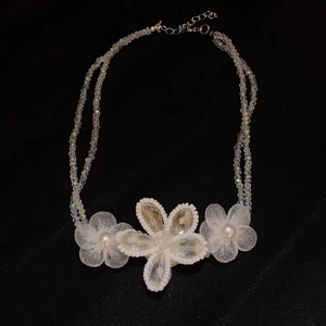 Close-up of chiffon flower necklace with crystal beads, pearls and lobster clasp closure