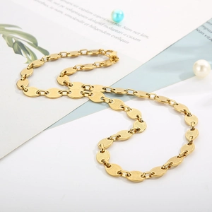 Detailed close-up of 18k gold plated titanium coffee bean chain with textured links