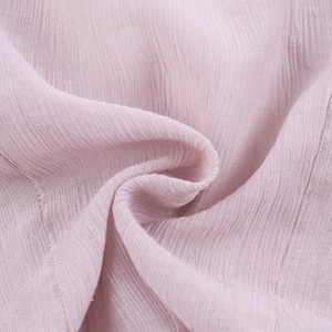Close-up of pink vertical ribbed fabric texture with delicate lace trim detailing