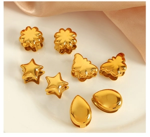 Macro detail of golden butterfly heart charms with polished finish on silk