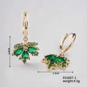 Detailed view of gold maple leaf earrings with green marquise stones and dimensions