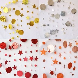 Star and circle paper garlands in gold, silver, red, and copper colors for party decoration