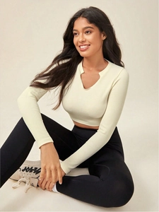 Detail of ribbed long sleeve yoga top with small V-neck in creamy white finish