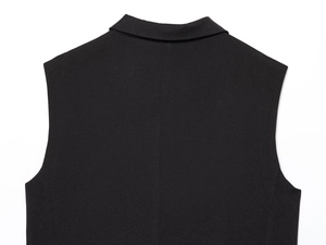 Detail of the back shoulder and twill woven texture of a black sleeveless suit vest