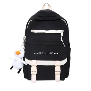 Close-up of black and white canvas backpack with CHEN HAO logo and duck pendant