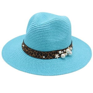 Elegant light blue Panama straw hat with leopard band, pearls and a white flower
