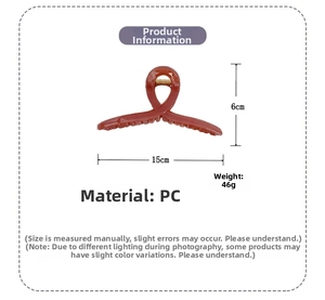 Détail d'une grande pince à cheveux de 15 cm marron-orange montrant les dimensions exactes