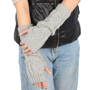 Detail of grey cable knit long fingerless gloves with ribbed cuffs for winter warmth