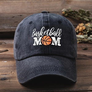 Vintage washed black cotton baseball cap with Basketball MOM white embroidery on wood desk
