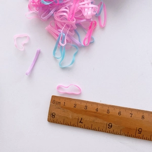 Detail view of elastic hair bands in ice cream colors with ruler showing 2cm size
