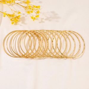 Bohemian gold layered bangle set featuring smooth and textured metallic finishes