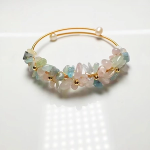 Detail of 14K gold wire wrap bracelet with pink and green crystal chips and pearls