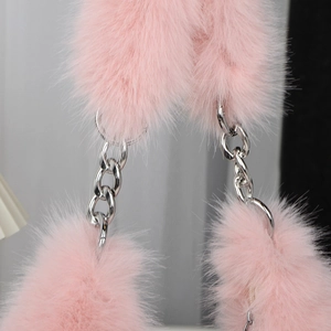 Close-up of pink faux fur shoulder bag with thick silver chain strap detail