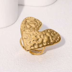 Detailed macro view of the gold heart-shaped ring with unique hammered texture finish