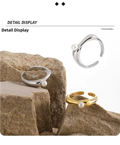 Detailed macro view of S925 silver wavy ring with pearl on a natural rock surface