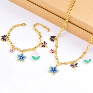 Detail of blue flower and butterfly jewelry set featuring gold chain and tulip beads
