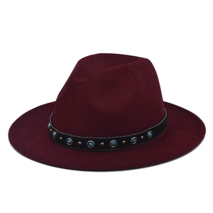 Close-up of wine red wool fedora featuring a black band with blue turquoise studs