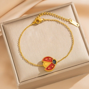 18k gold plated ladybug and shell flower bracelet on beige gift box and satin