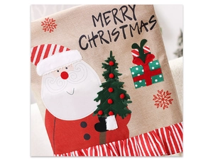 Detail of burlap Christmas chair cover with Santa, tree motifs and red striped ruffle edge