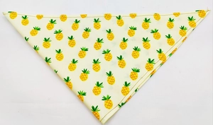 Detailed view of yellow cotton pet bandana with pineapple patterns and stitching