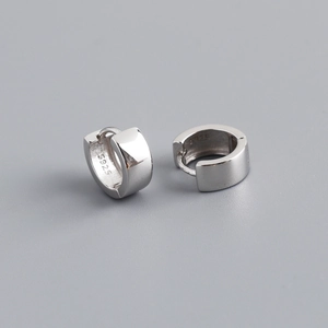 Macro detail of the silver S925 sterling silver stamp on the polished hoop earrings