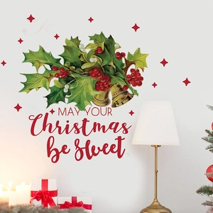 Detail of Christmas wall stickers with holly leaves, red berries, and holiday greetings