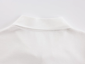 Close-up of white knitted polo shirt collar and neckline detail in vintage style