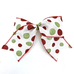 Détail de nœud de Noël blanc avec pois pailletés rouges et verts et bordure rouge brodée