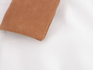 Macro detail of the vintage corduroy dress lapel collar in brown and white tones
