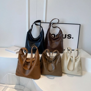 Retro minimalist underarm tote bags in five colors on a professional studio display