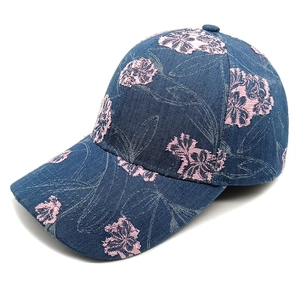 Detailed view of floral embroidery and denim texture on a blue baseball cap