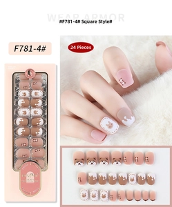 Close-up of matte brown and pink press-on nails with cute bear and rabbit patterns