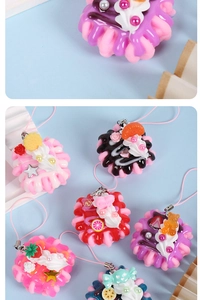 Close-up of strawberry cream dessert keychain with resin stars and pearls detail