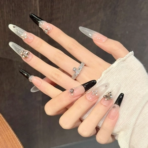 Purple cat eye stiletto press-on nails with black French tips and crystal accents