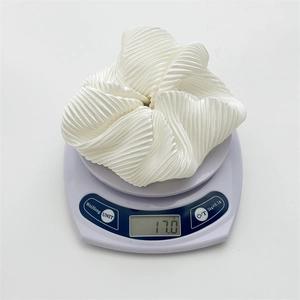 Detailed view of the 17.0g weight of this oversized creamy white pleated hair scrunchie