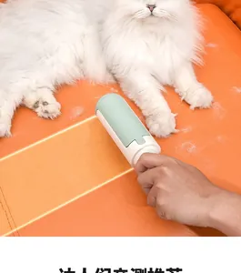 Detail showing hand using the green pet hair remover tool on an orange leather sofa