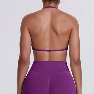 Detail of deep purple backless sports bra with thin halter straps and seamless texture