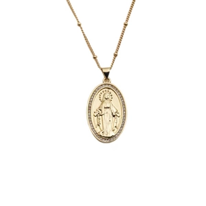 Detail view of a gold oval Virgin Mary pendant with sparkling zircon gemstones