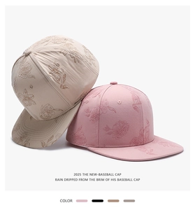Detail of twill cotton baseball caps with elegant floral embroidery in beige and pink