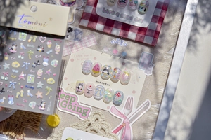 Detail of Tomoni 3D nail stickers featuring cute cats, coconut trees and embossed textures