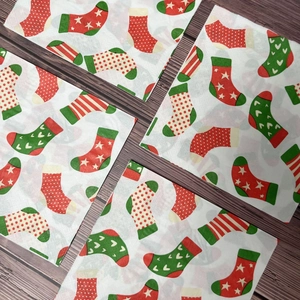 Christmas stocking pattern paper napkins with stars and stripes on wooden background