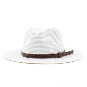 Close-up of white straw cowboy hat with a brown floral embossed leather band detail