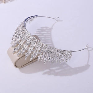 Detail of silver rhinestone crown with teardrop crystal tassels on a display stand