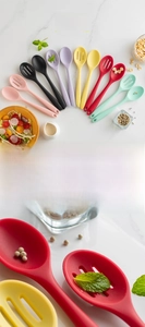 Macro view of food-grade silicone solid and slotted spoons in assorted colors