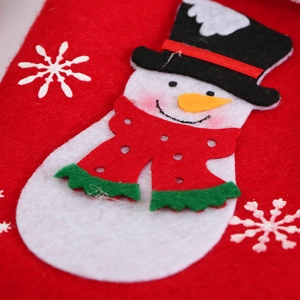 Close-up of a red felt Christmas stocking featuring a white snowman applique with hat