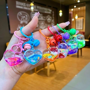 Colorful heart-shaped liquid quicksand keychains set with floating glitter sequins