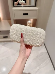 Elegant white pearl evening clutch bag with golden metal clasp for wedding and party gala