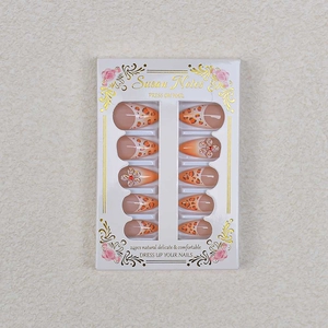 Detail of French leopard print press-on nails with 3D rhinestone flowers and almond shape