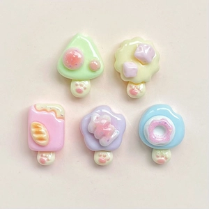 Flat lay of colorful resin donut and ice cream DIY accessories for crafts and hair clips